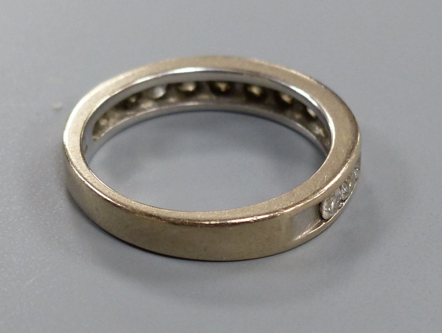 A diamond and 18ct white gold half eternity ring, size M, gross 4.5 grams.